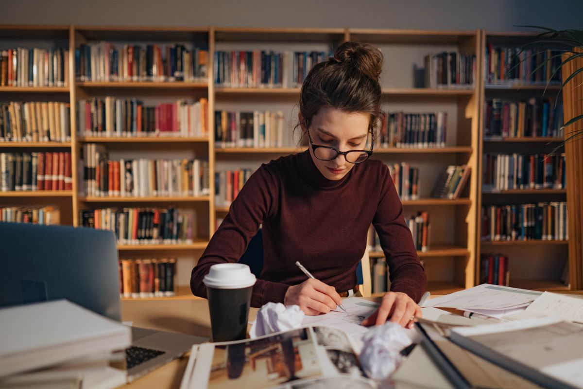 A scholarship recipient studying in the library
