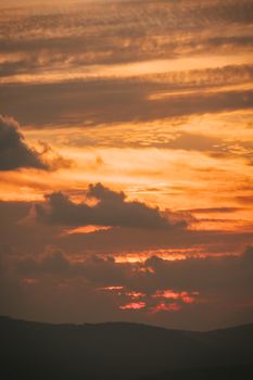 Beautiful golden sunset with dramatic clouds and glowing sky, perfect for serene landscapes.