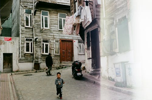 Free Child Running in the Street in an Old Town  Stock Photo