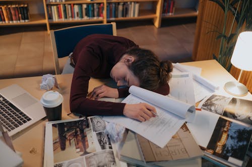Free Tired Woman Sleeping on Desk Stock Photo