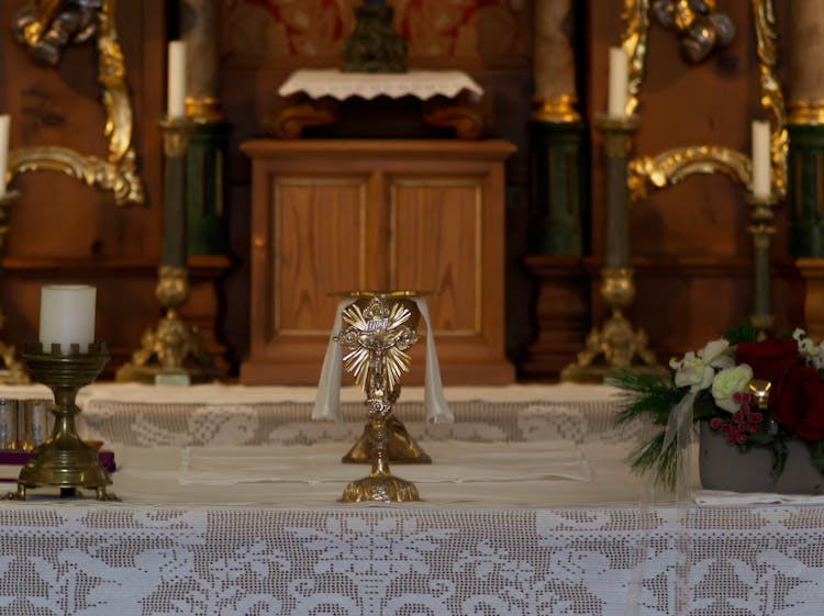 Gold Crucifix And Chalice On Altar