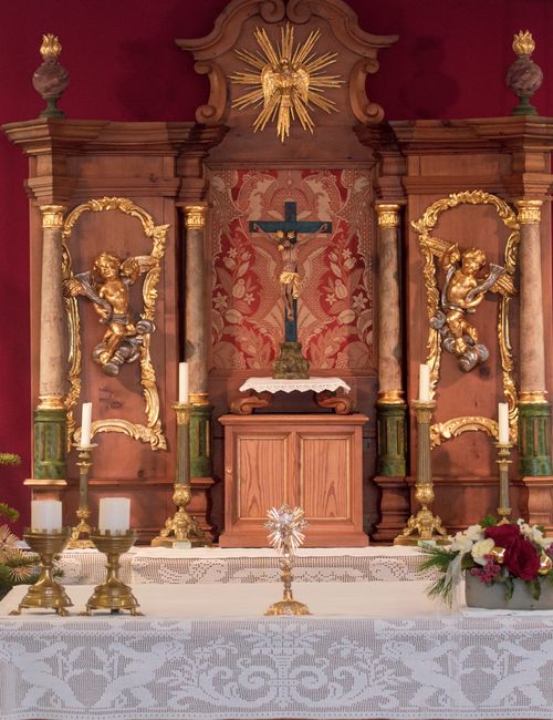 Free Elegant church altar featuring ornate carvings, cross, and religious symbols, perfect for worship and spirituality themes. Stock Photo