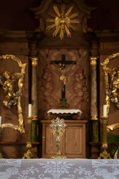 Free An ornate church altar featuring gold accents, a crucifix, and intricate artwork, perfect for religious and spiritual content. Stock Photo