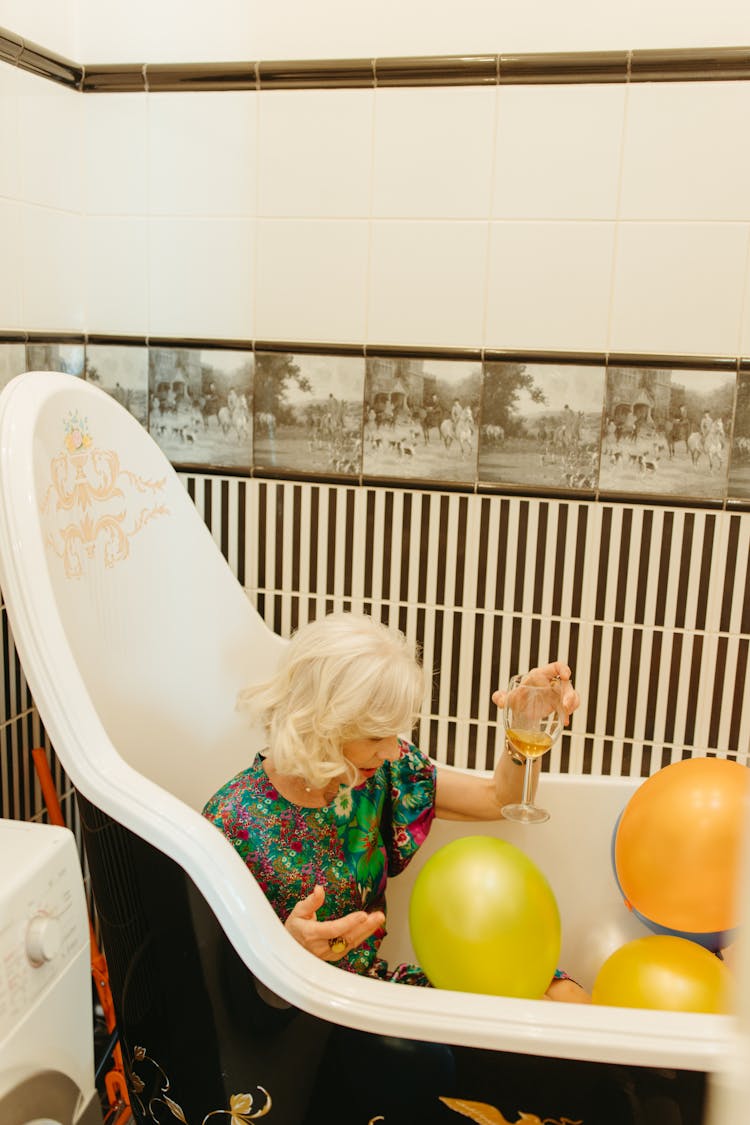 Elderly Woman In The Bathtub With Balloons