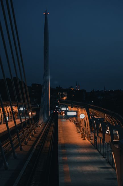 Stunning night view of a lit suspension bridge in İstanbul with urban surroundings.