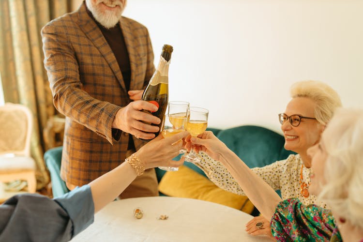 A Group Of People Toasting Drinks