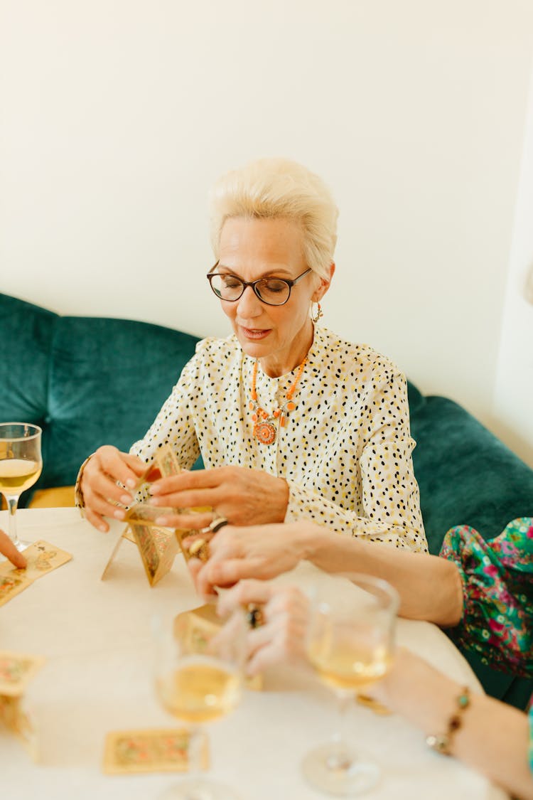 An Elderly Woman In Printed Long Sleeves Wearing Eyeglasses