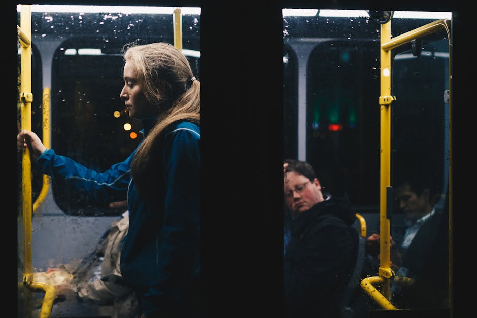 Photo of a Woman Standing Inside Bus