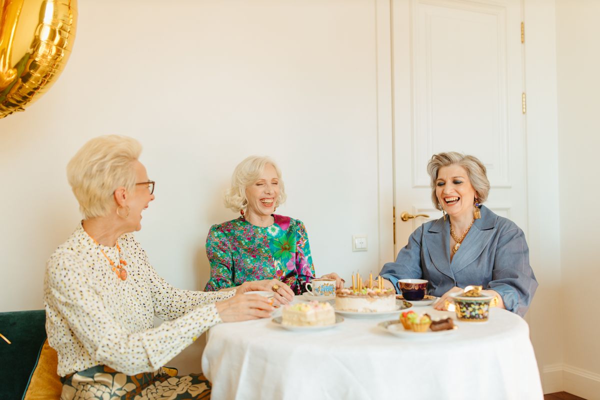 Two elderly women laughing together