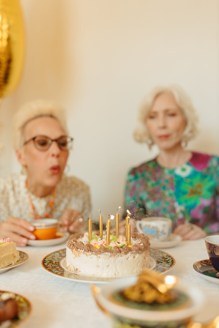 Woman Blowing The Candle 