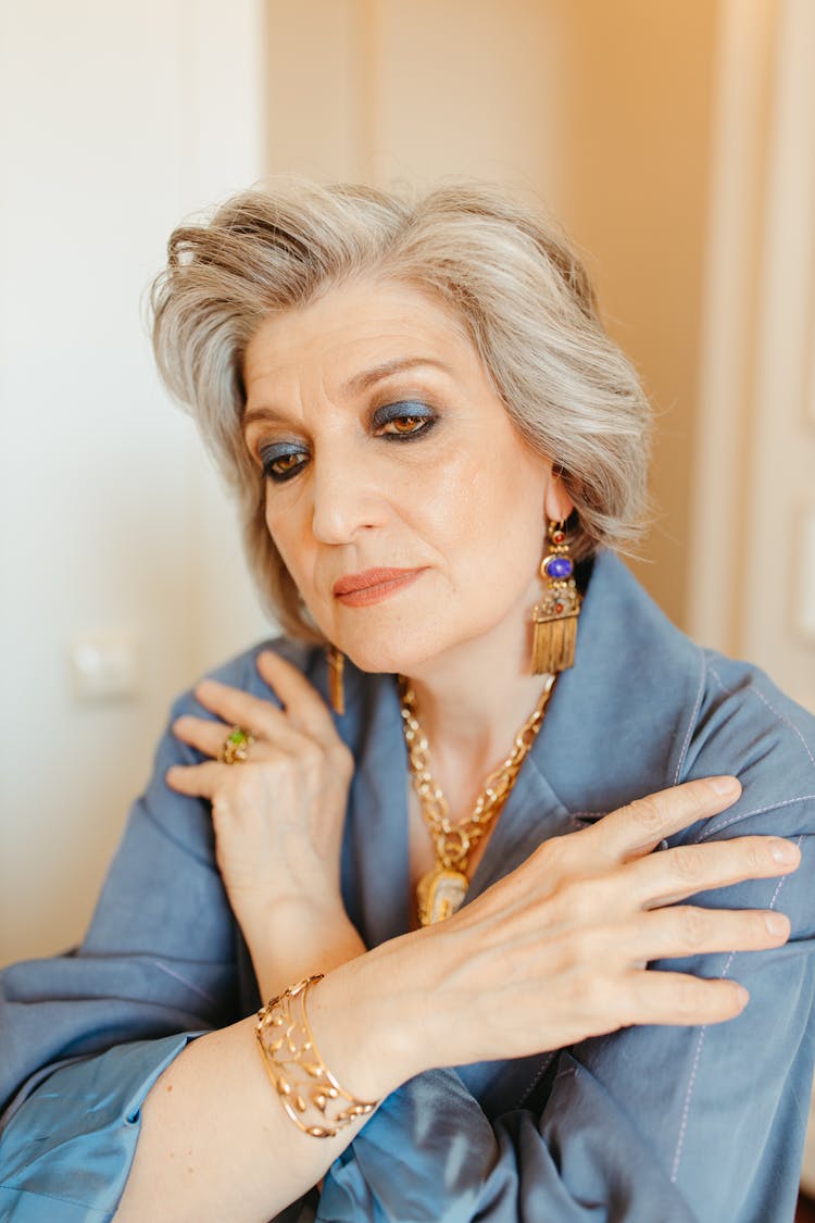 Woman In Blue Long Sleeve Wearing Gold Accessories