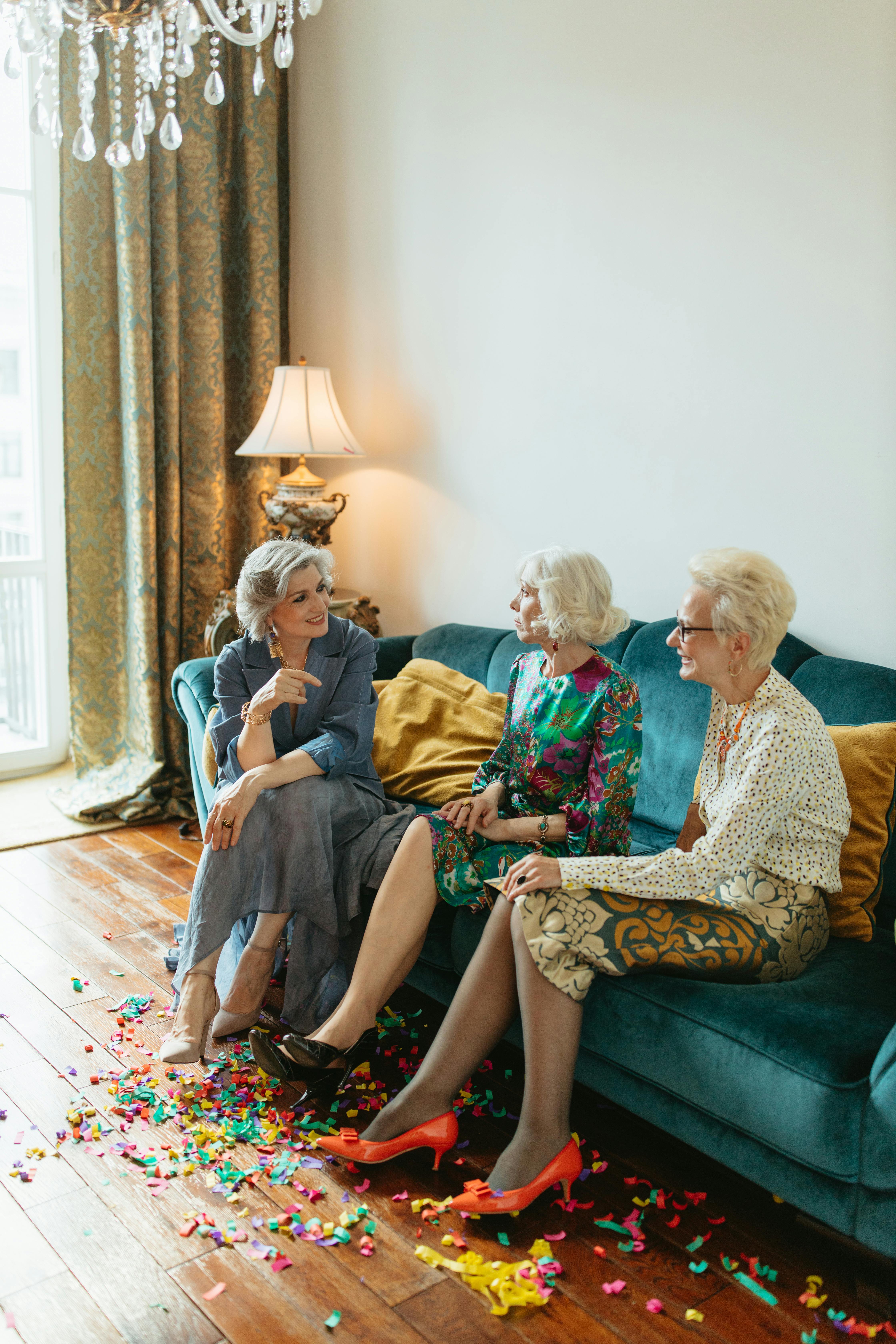 elderly women sitting on couch while talking