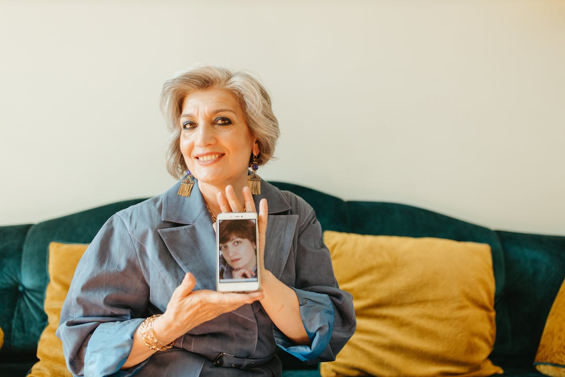 Elderly Woman Showing Her Vintage Photo