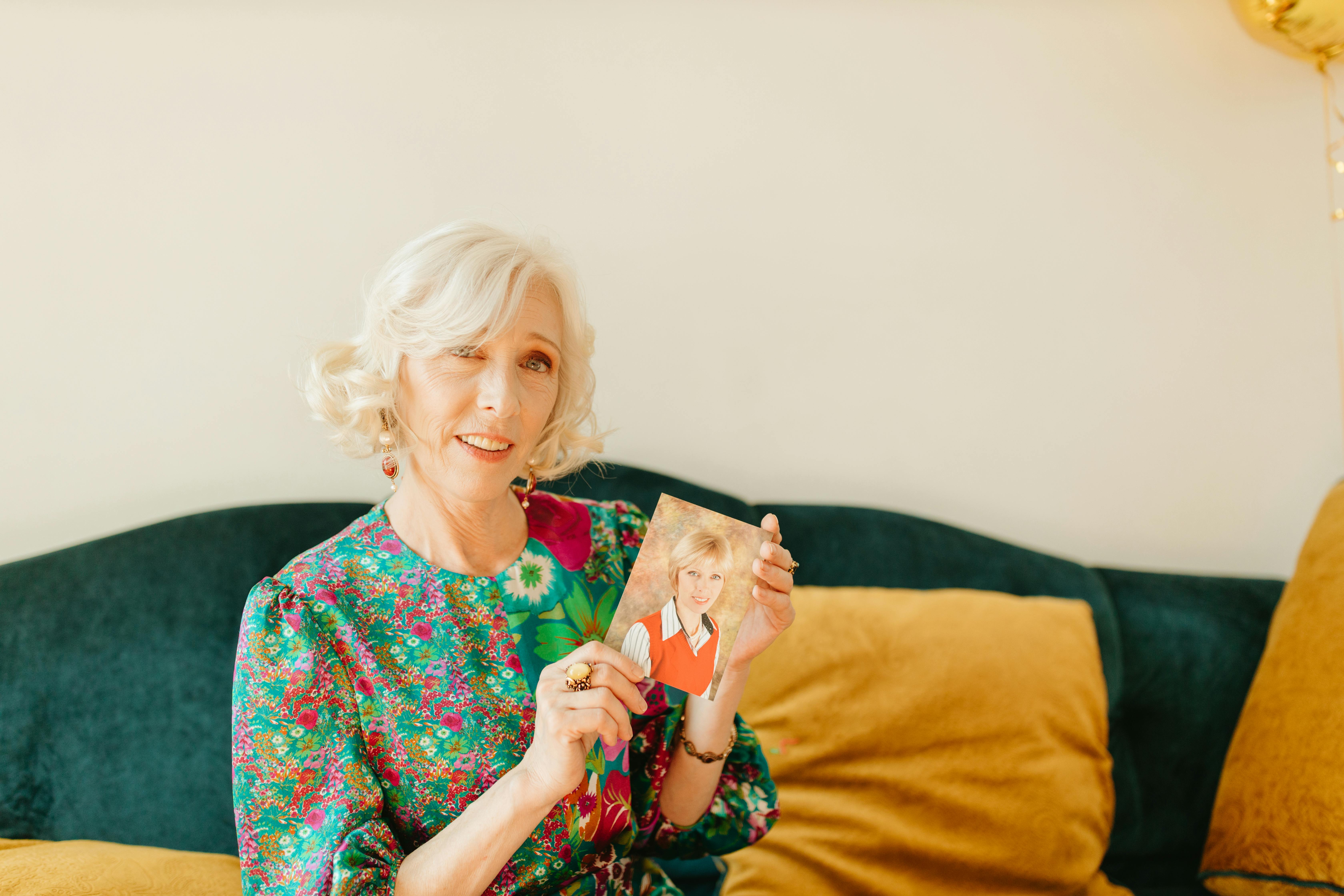 elderly woman showing her vintage photo