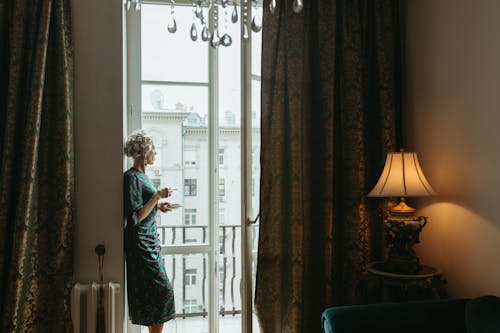 Woman Standing Near Glass Door