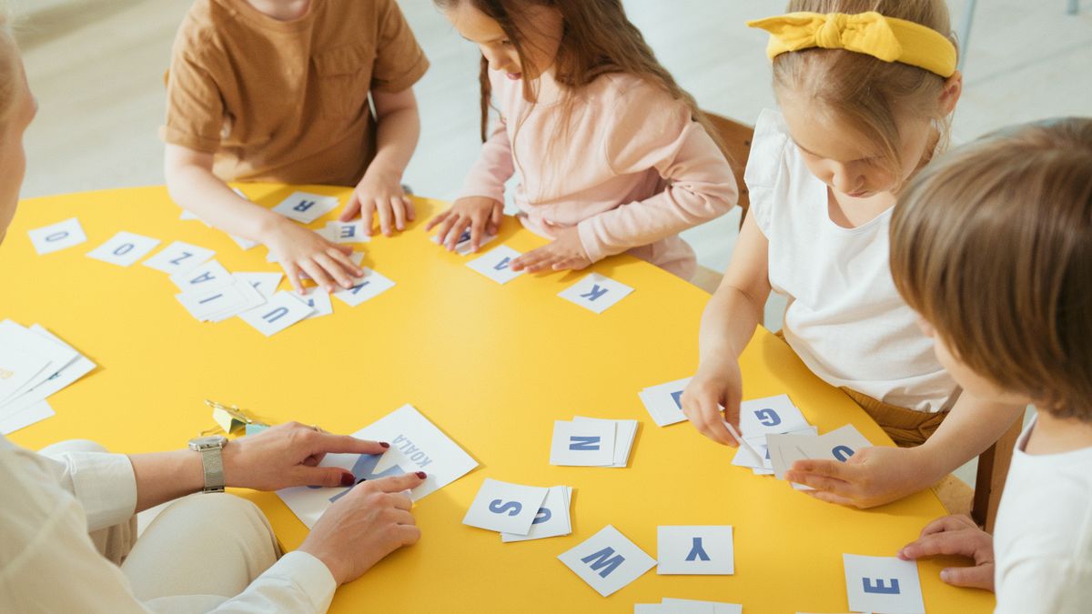 Children using colorful counting pieces and construction materials during a supervised STEM learning activity