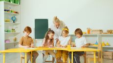 Blonde Woman Checking the Kids Writing