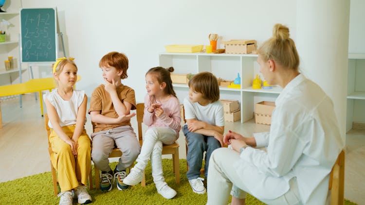 Kids Sitting On Chairs