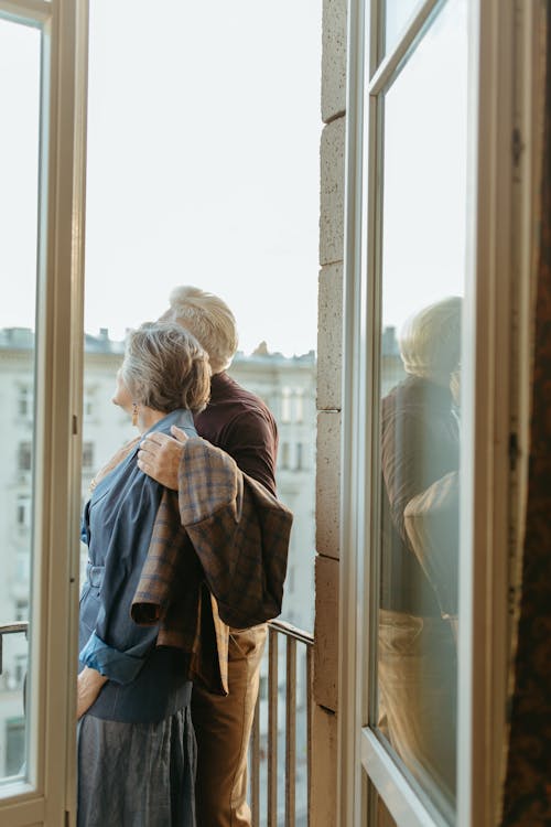 Free Elderly Couple Standing at the Balcony  Stock Photo