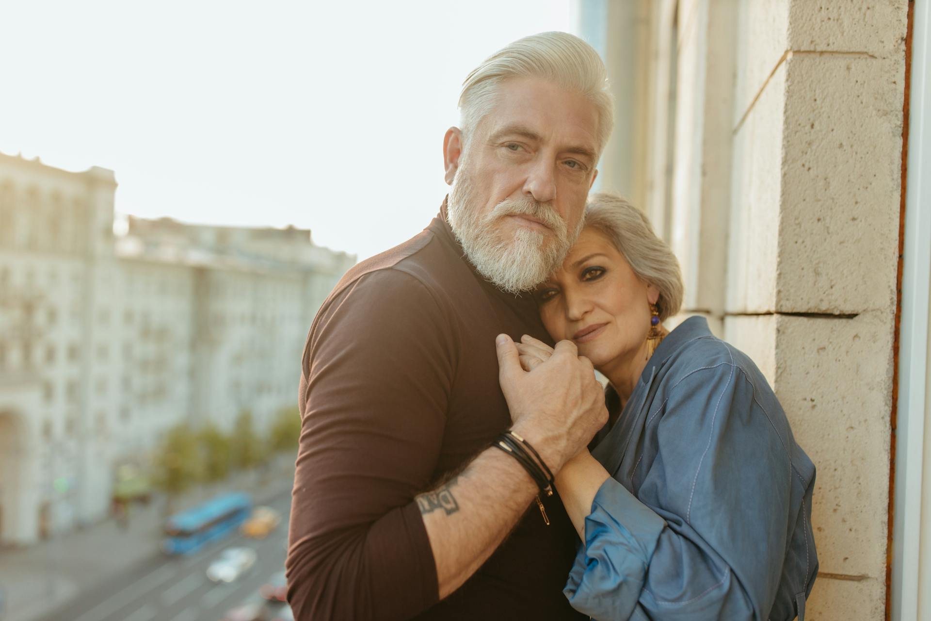 A senior couple embracing tenderly outdoors, showcasing love and connection.