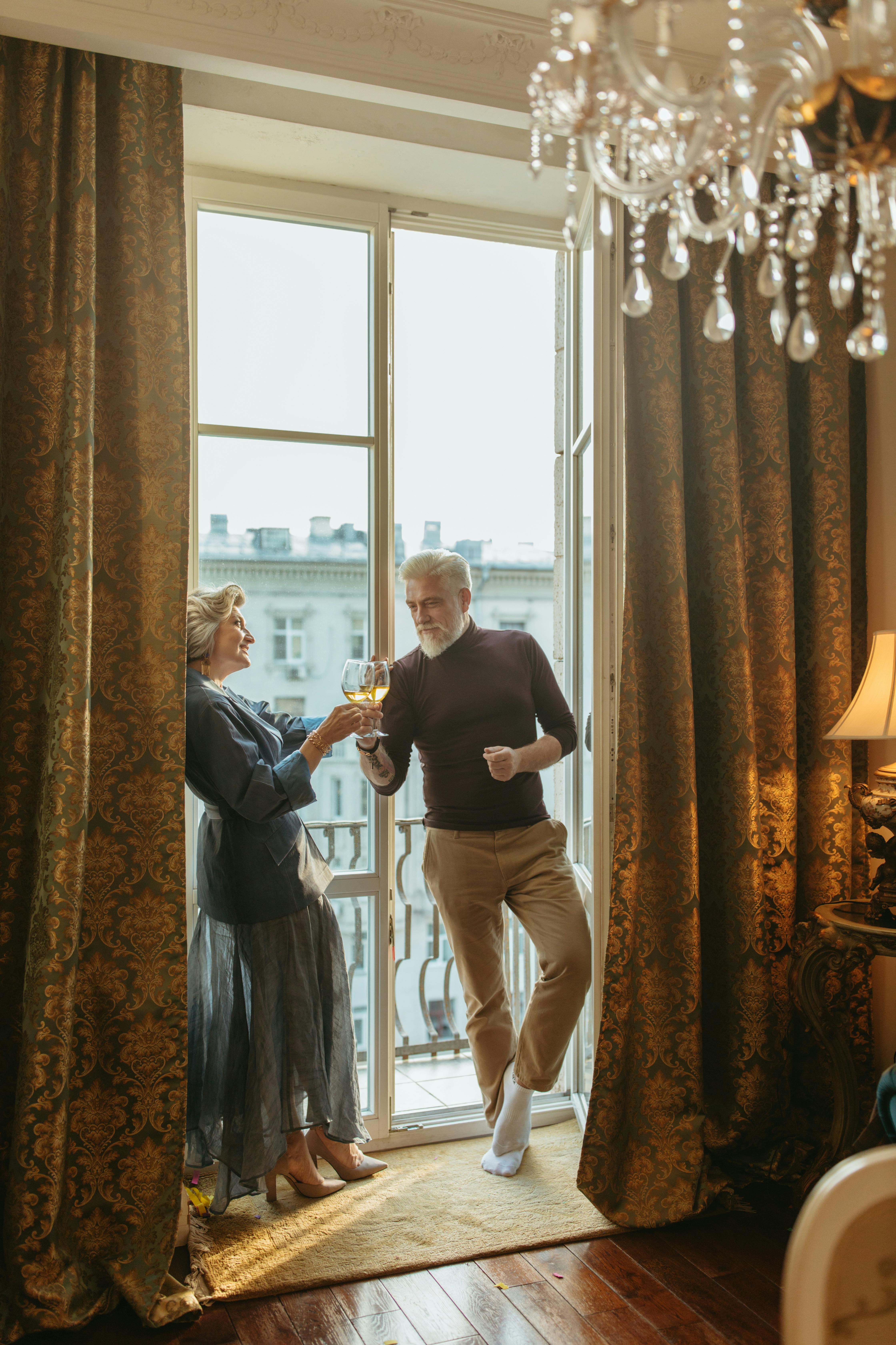 a couple toasting their glasses of wine