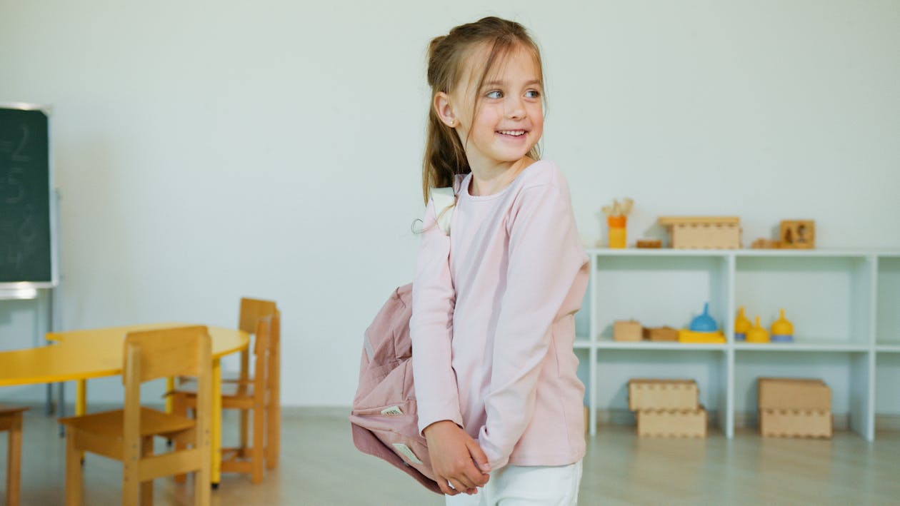 A Cute Girl in Pink Long Sleeve Shirt Smiling