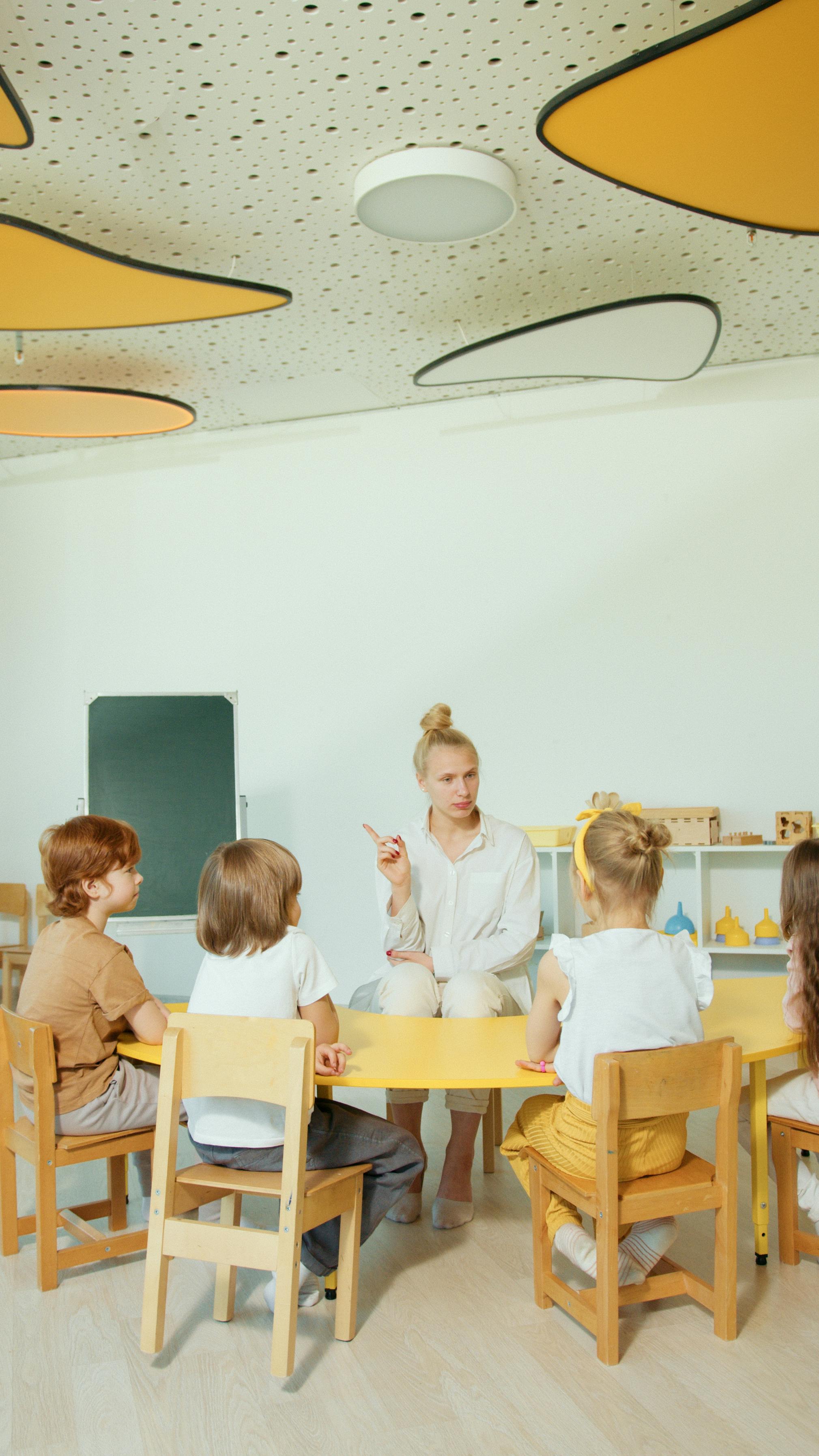 children sitting on brown wooden chairs