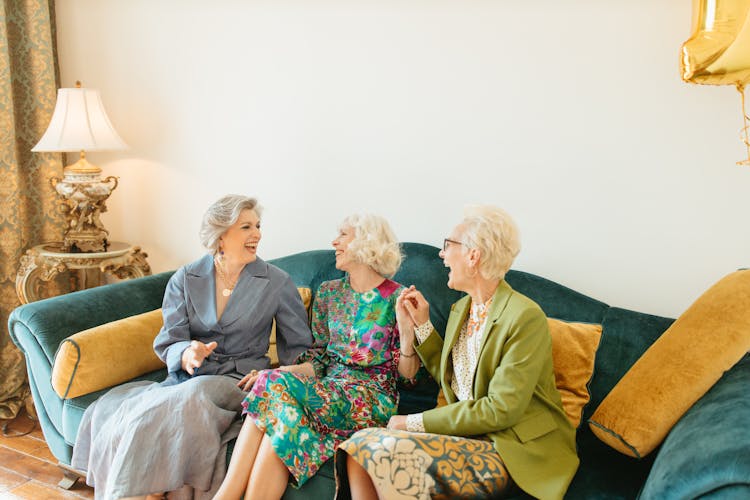 Laughing Elderly Women Sitting On Couch