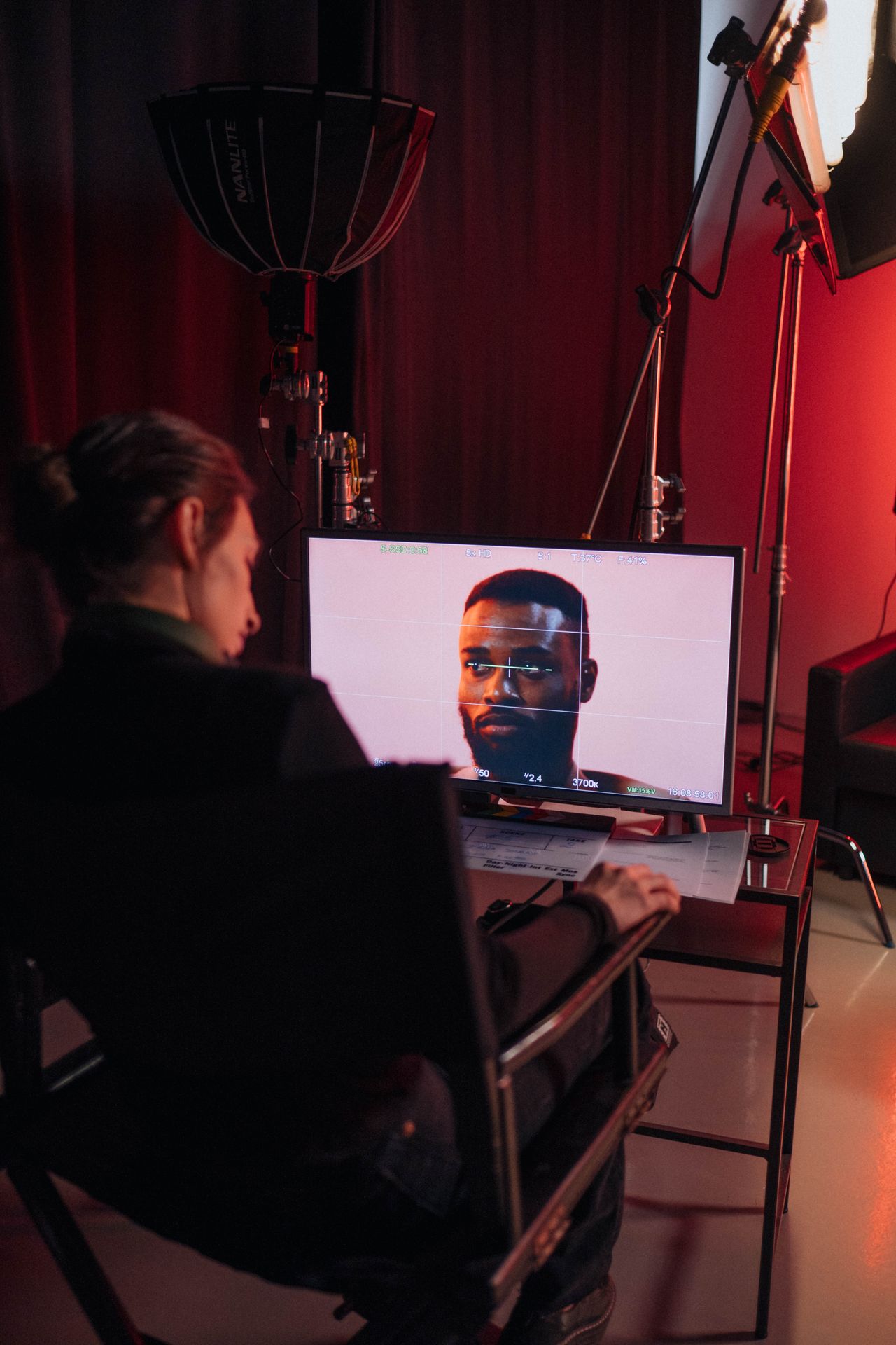 Video editing professional working with advanced production monitors in a real studio