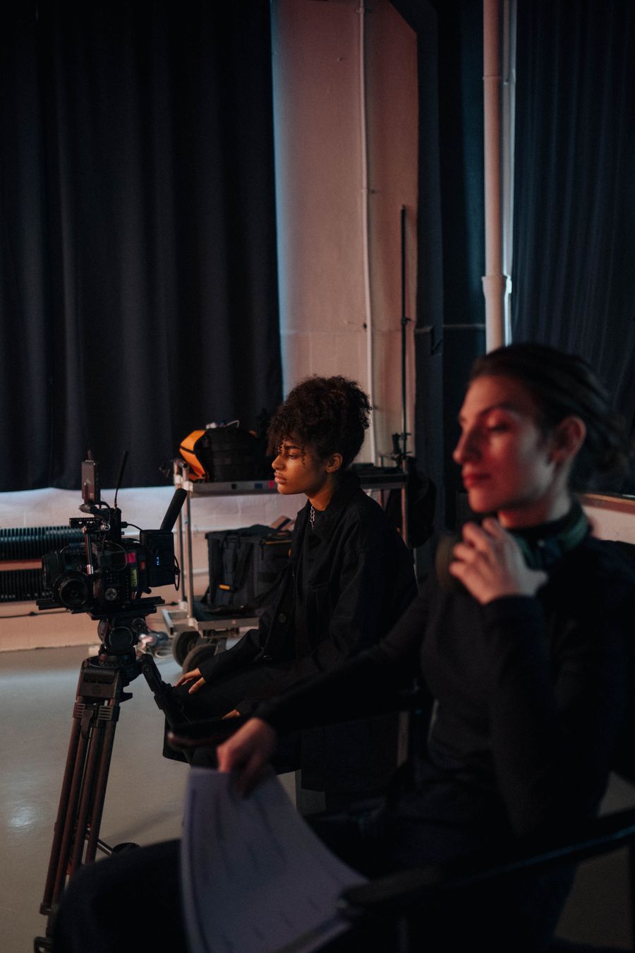 Videographer operating a camera with a professional rig indoors