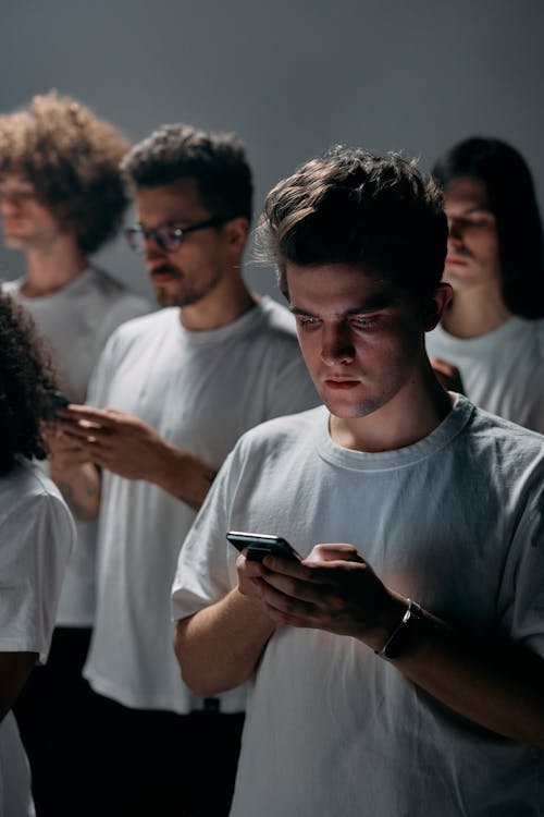 Man Using Many Phones Photo of Man Using Smartphone · Free Stock Photo