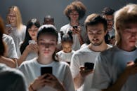 Photo of People Engaged on their Phones