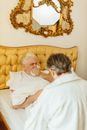 Gray Haired Man Covering his Mouth While Coughing