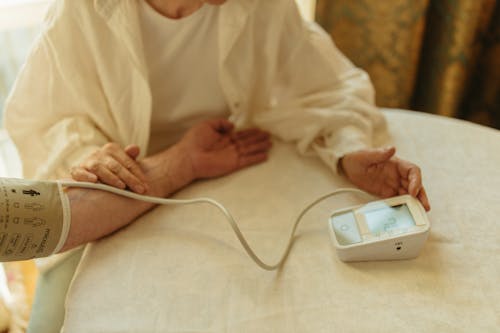 Free Person Using a Digital Blood Pressure Monitor  Stock Photo