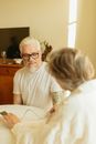 Gray Haired Person Checking the Man's Blood Pressure