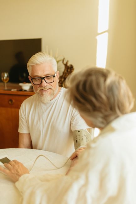 senior measuring blood pressure at home