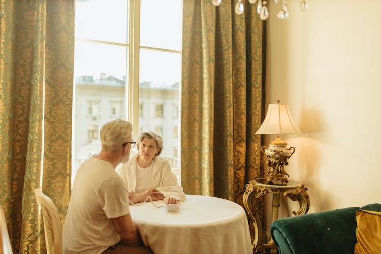 Adult Woman Monitoring The Man's Blood Pressure 