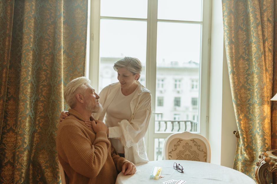 Elderly couple enjoying a heartfelt moment at home, embodying care and companionship.