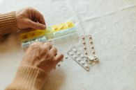 Close-Up Shot of a Person Putting Medicines in a Pillbox