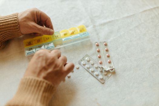 Close-Up Shot of a Person Putting Medicines in a Pillbox