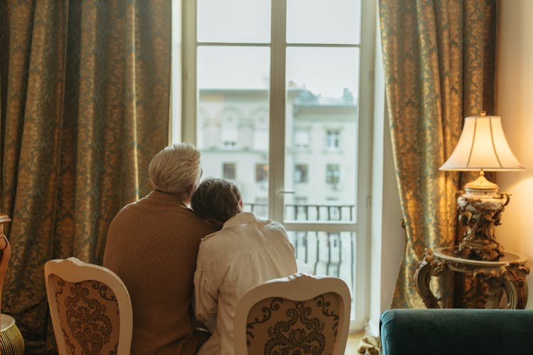 Elderly Couple Sitting While Looking Outside