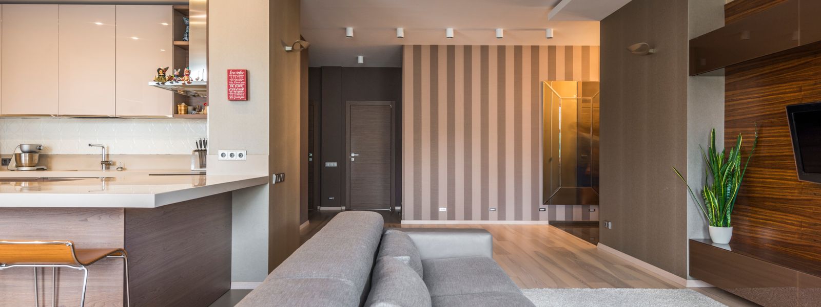 Spacious living room with a modern, minimalist design and open kitchen layout.