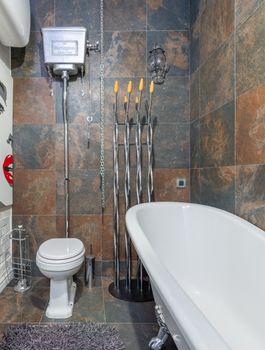 Modern bathroom featuring a vintage freestanding bathtub with elegant decor and stylish tilework.