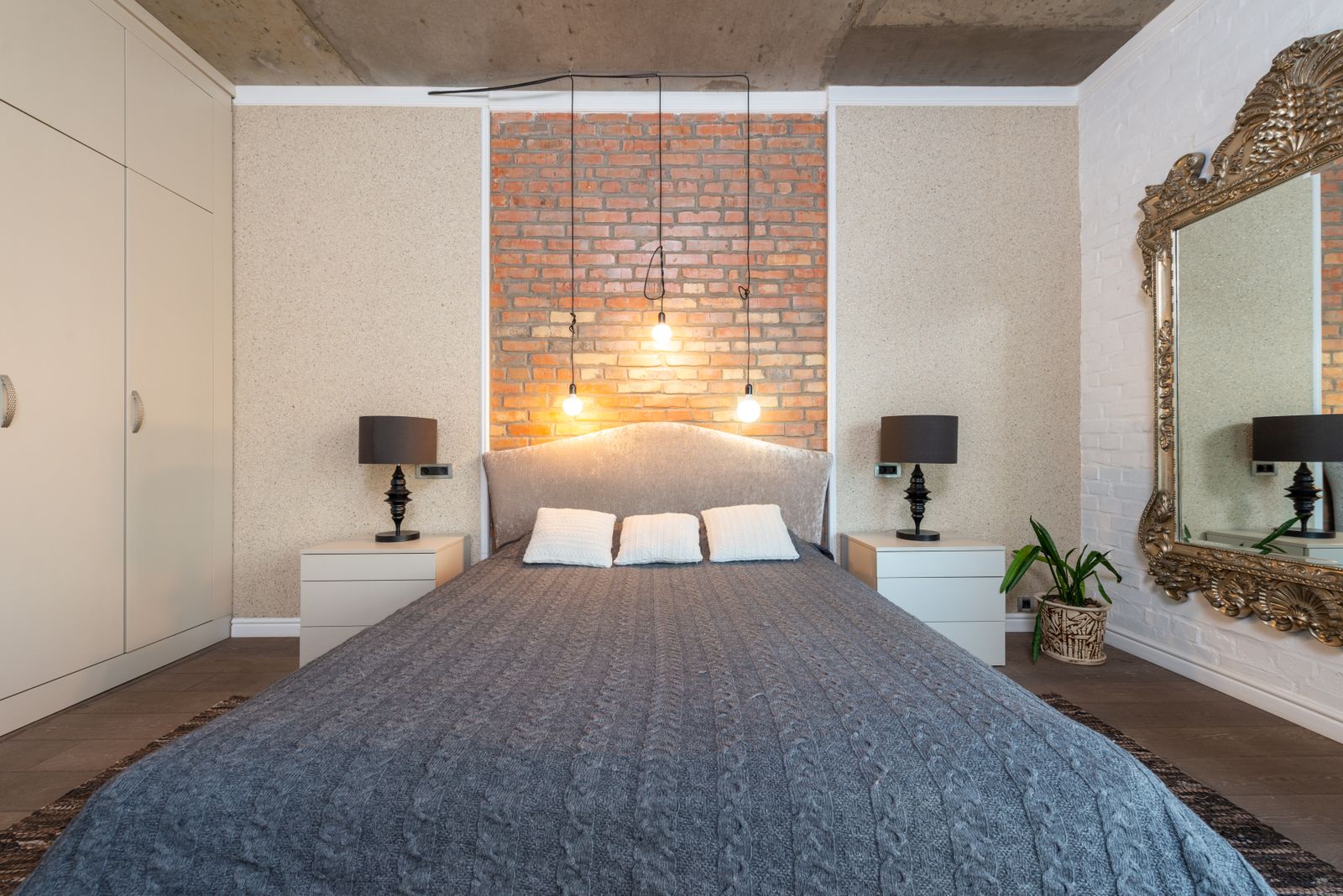 Cosy bedroom with a made bed and warm lighting