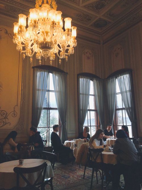 Free A cozy café in Istanbul with a classic chandelier and large windows, capturing an elegant ambiance. Stock Photo