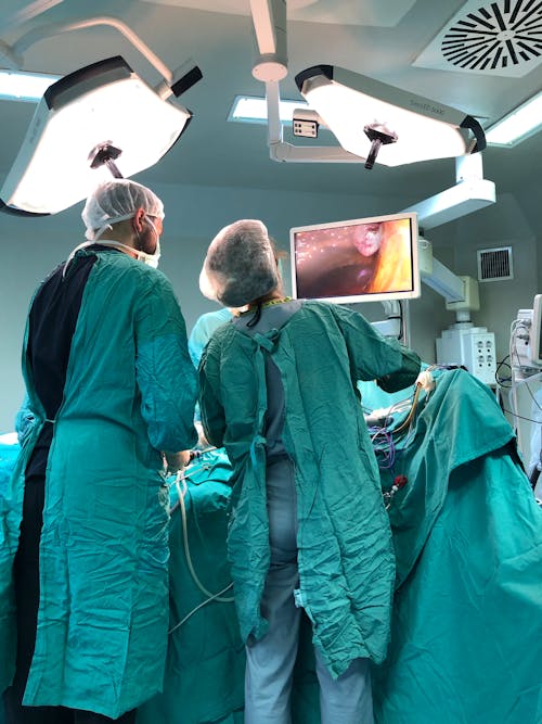 Free Doctors Performing a Surgery in an Operating Theatre Stock Photo