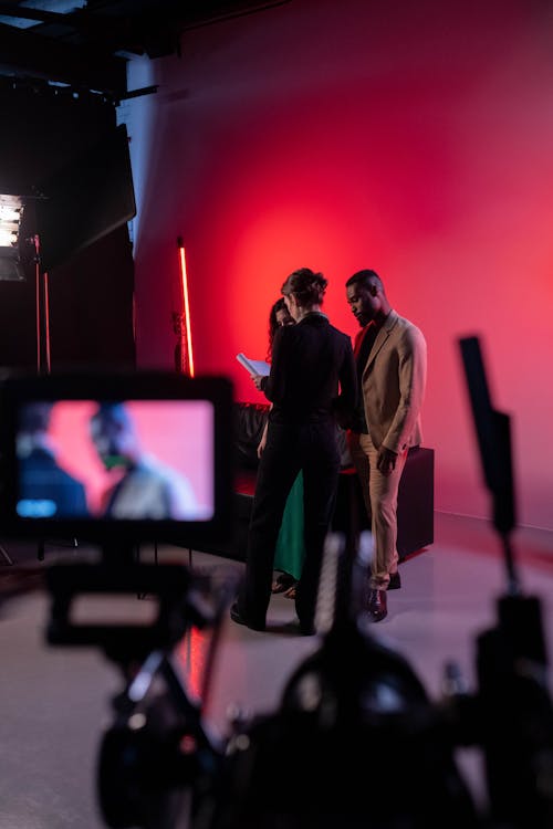 Group of People Standing Looking at the Script 