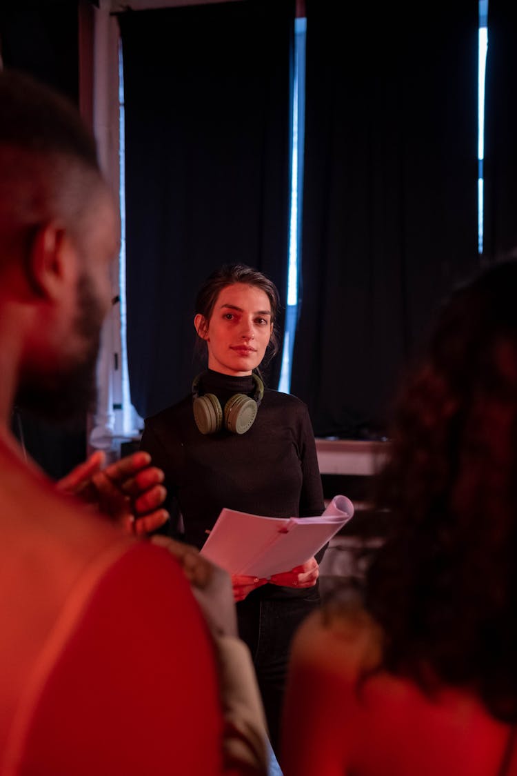 Woman In Black Long Sleeves Holding The Scripts 