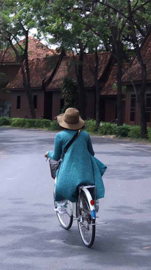 Free Person Wearing a Brown Hat Riding a Bicycle  Stock Photo