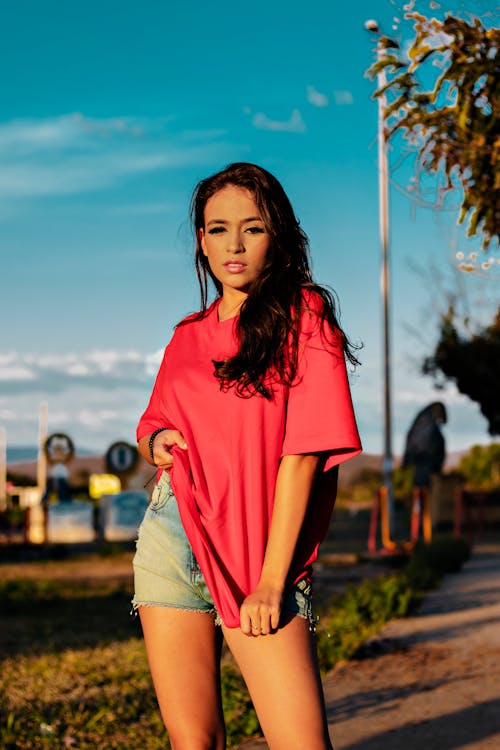 Woman Posing In Red T-Shirt and Denim Shorts